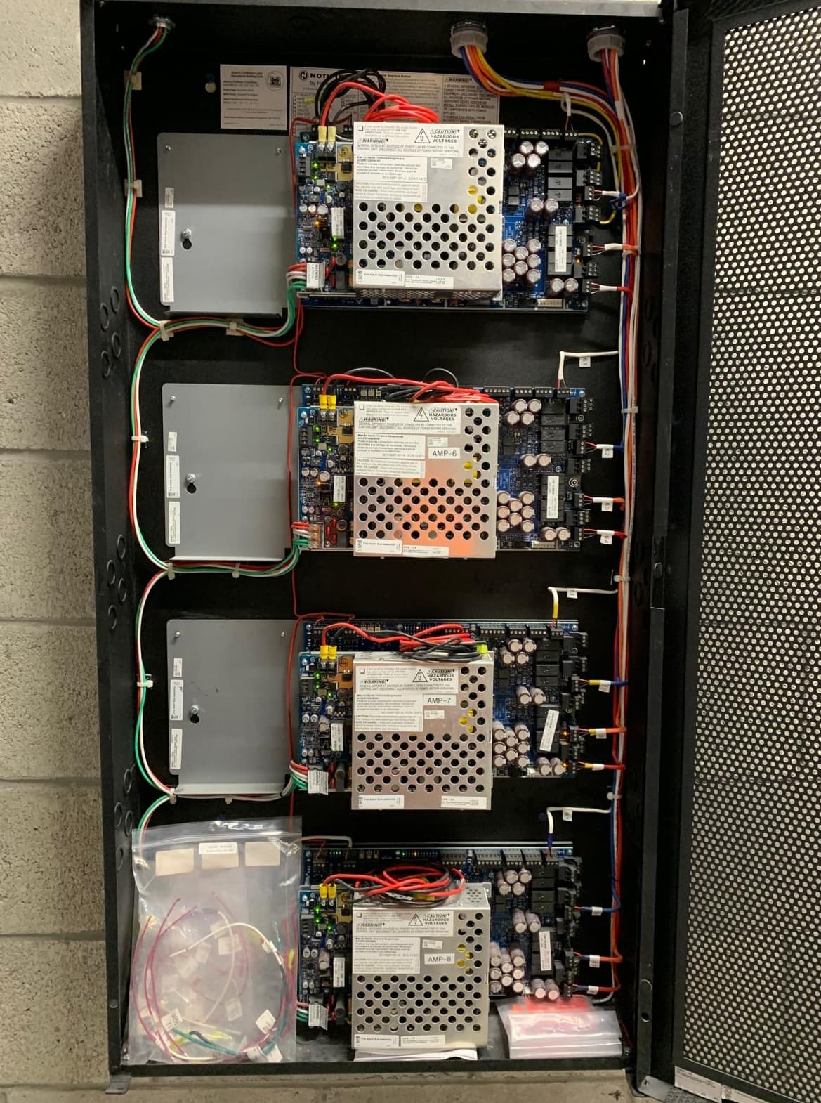 Fire alarm power supply panels mounted in an enclosure