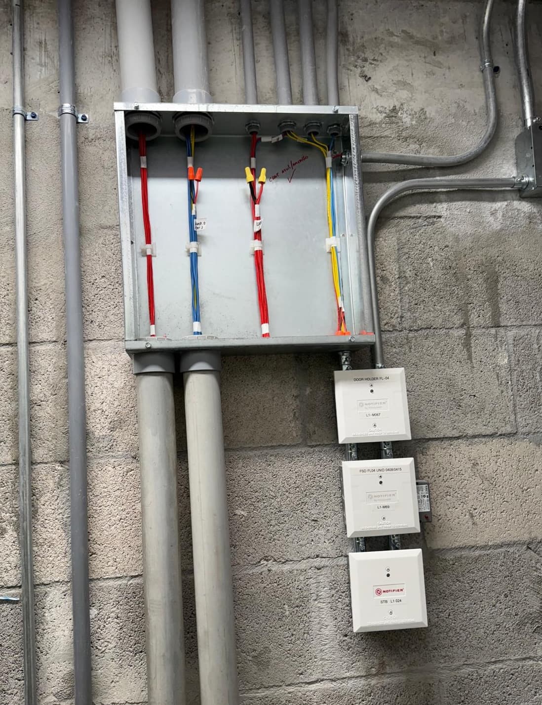 Wago-style junction box with red, yellow, and blue conductors